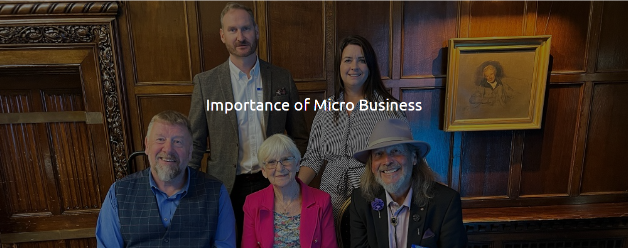 Five members of the Micro Business Alliance in a wood-panelled room, with the words Importance of Micro Business